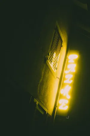 A Neon Sign On A Building Wallpaper