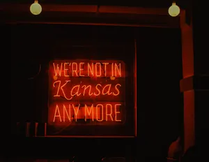 A Neon Sign That Says We're Not In Kansas Anymore Wallpaper