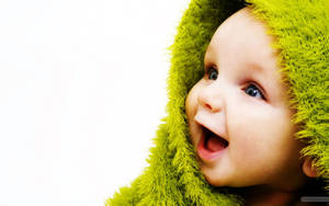 A Newborn Baby Sleeping In A Nest Of Soft Fabric Wallpaper