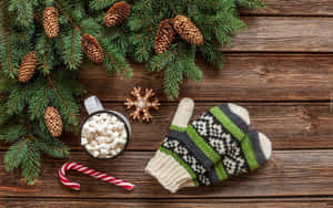 A Pair Of Cozy Wool Mittens On A Wooden Surface Wallpaper