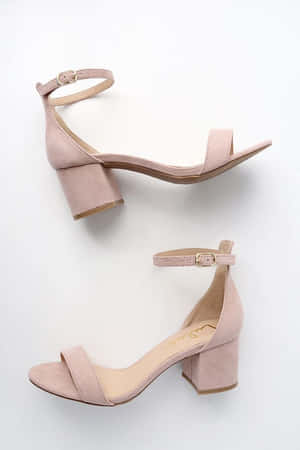 A Pair Of Stylish Sandals On A Sandy Beach Wallpaper