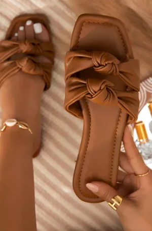 A Pair Of Stylish Sandals On A Wooden Floor Wallpaper