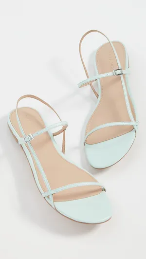 A Pair Of Stylish Sandals On The Beach Wallpaper