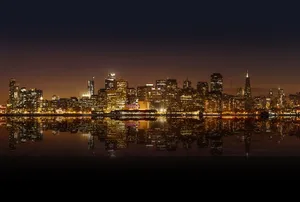 A Panoramic View Of The Colorful Lights Of San Francisco At Night Wallpaper