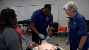 A Paramedic Performing Intubation During Workshop Wallpaper