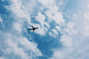 A Passenger Airplane Soaring High In The Sky. Wallpaper