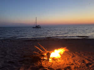 A Peaceful Beach Bonfire Gathering Wallpaper