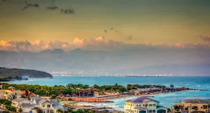 A Peaceful Landscape With Trees, Rocks And Crystal-clear Water Wallpaper