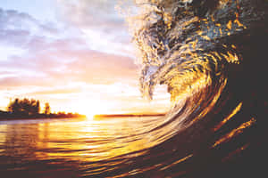 A Peaceful View Of The Setting Sun Reflected By A Wave Wallpaper