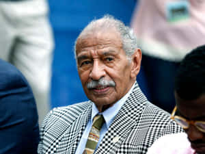 A Pensive John Conyers At A Public Event Wallpaper