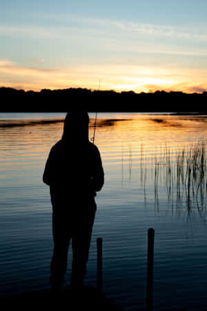 A Person Fishing On A Dock Wallpaper