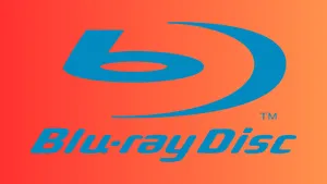 A Person Holding A 4k Blu-ray Disc In Front Of A 4k Blu-ray Player And Tv Setup Wallpaper