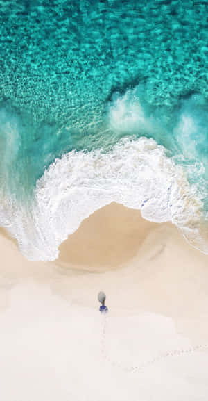 A Person Is Standing On A Beach With A Umbrella Wallpaper