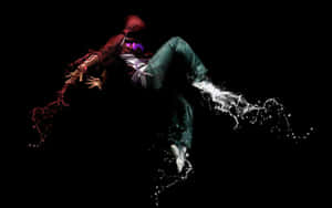 A Person Jumping In The Air With A Black Background Wallpaper