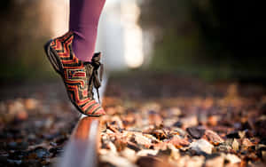 A Person's Feet On A Rail Wallpaper