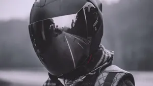 A Person Wearing A Helmet On A Road Wallpaper