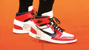 A Person Wearing A Pair Of Air Jordan 1 High Sneakers Wallpaper