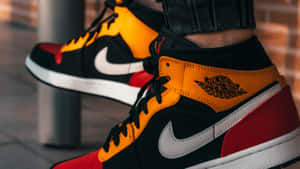 A Person Wearing A Pair Of Air Jordan 1 High Sneakers Wallpaper