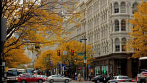 A Picturesque Fall Town Surrounded By Vibrant Foliage Wallpaper