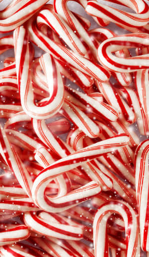 A Pile Of Candy Canes With A White Background Wallpaper