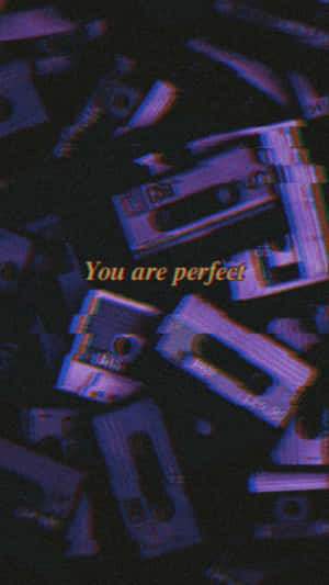 A Pile Of Cassette Tapes With The Words You Are Perfect Wallpaper