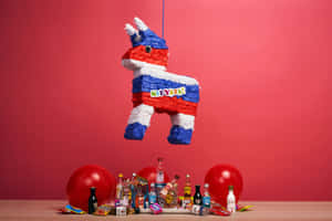 A Pinata Hanging From A Red Table With Balloons And Drinks Wallpaper