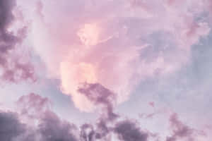 A Pink And Purple Sky With Clouds Wallpaper