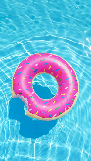 A Pink Donut Floating In The Pool Wallpaper