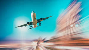 A Plane Flying Over A City With Blurred Background Wallpaper