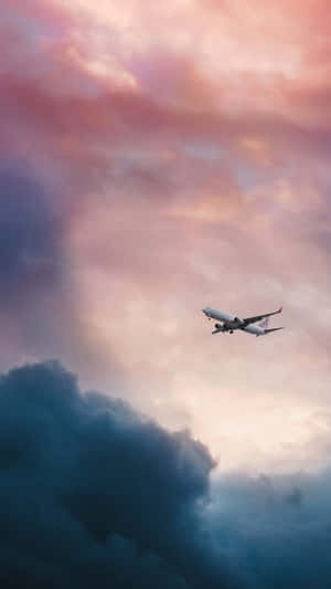 A Plane Flying Through A Cloudy Sky Wallpaper