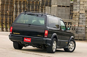 A Powerful Gmc Typhoon Cruising On The Road. Wallpaper