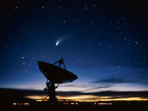 A Powerful Radio Telescope Scanning The Depths Of Space From A Serene Landscape Wallpaper