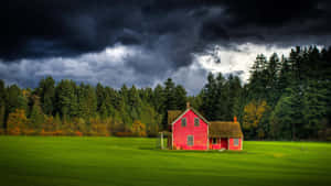 A Pristine Farmhouse In The Middle Of A Serene Meadows Wallpaper