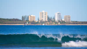 A Pristine Sunshine Coast Beach At Sunrise Wallpaper