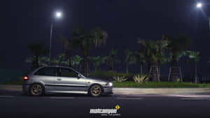 A Proton Car Speeding Down The Highway Wallpaper