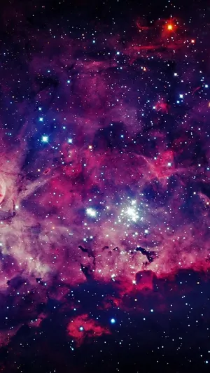 A Purple And Blue Space With Stars And Nebulas Wallpaper