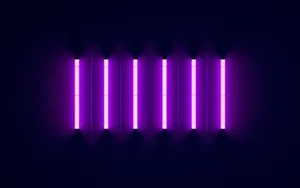 A Purple Light Is Shown On A Dark Background Wallpaper