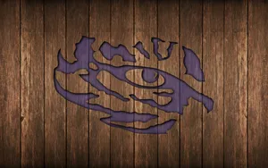 A Purple Logo On A Wooden Background Wallpaper