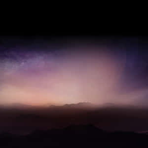 A Purple Sky With Mountains And Clouds Wallpaper