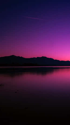 A Purple Sky With Mountains Wallpaper