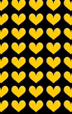 A Radiant Yellow Heart On A Subtle Black Background Wallpaper