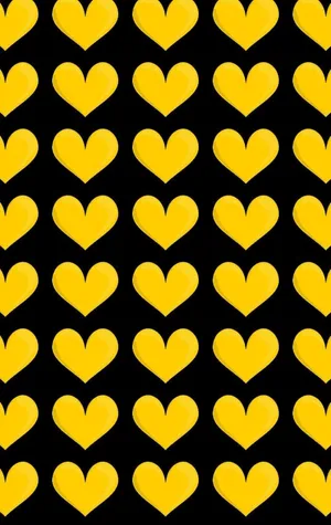 A Radiant Yellow Heart On A Subtle Black Background Wallpaper