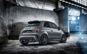 A Red Abarth Sports Car In Action On An Urban Road. Wallpaper