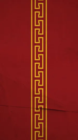 A Red And Yellow Pattern On A Red Background Wallpaper