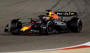 A Red Bull Racing Car Is Driving On A Track Wallpaper