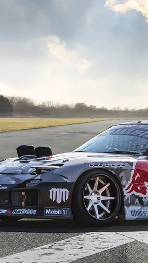 A Red Bull Racing Car On A Track Wallpaper