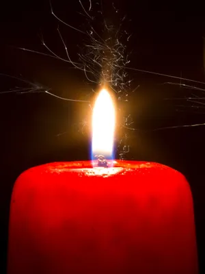 A Red Candle With A Spark Of Fire Wallpaper