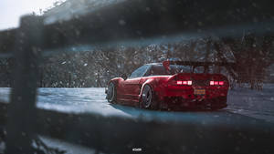 A Red Car Driving Down A Snowy Road Wallpaper