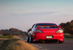 A Red Car Is Parked On A Country Road Wallpaper