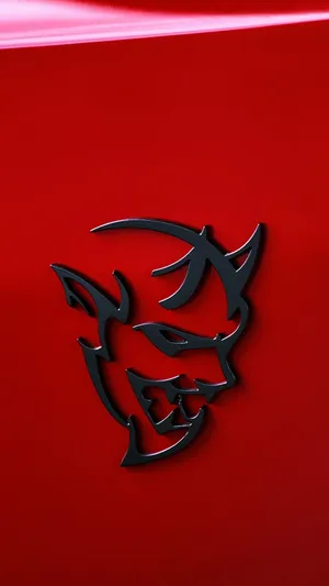 A Red Car With A Devil Hood Emblem Wallpaper